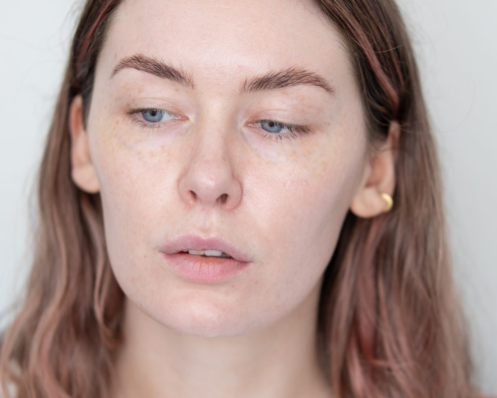 close up image of a person's face with visible freckles