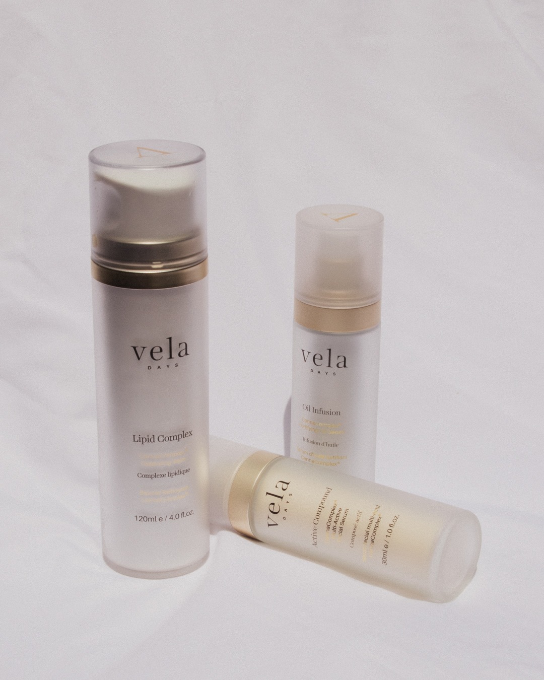 vela days oil cleanser, serum, and face oil against a white backdrop
